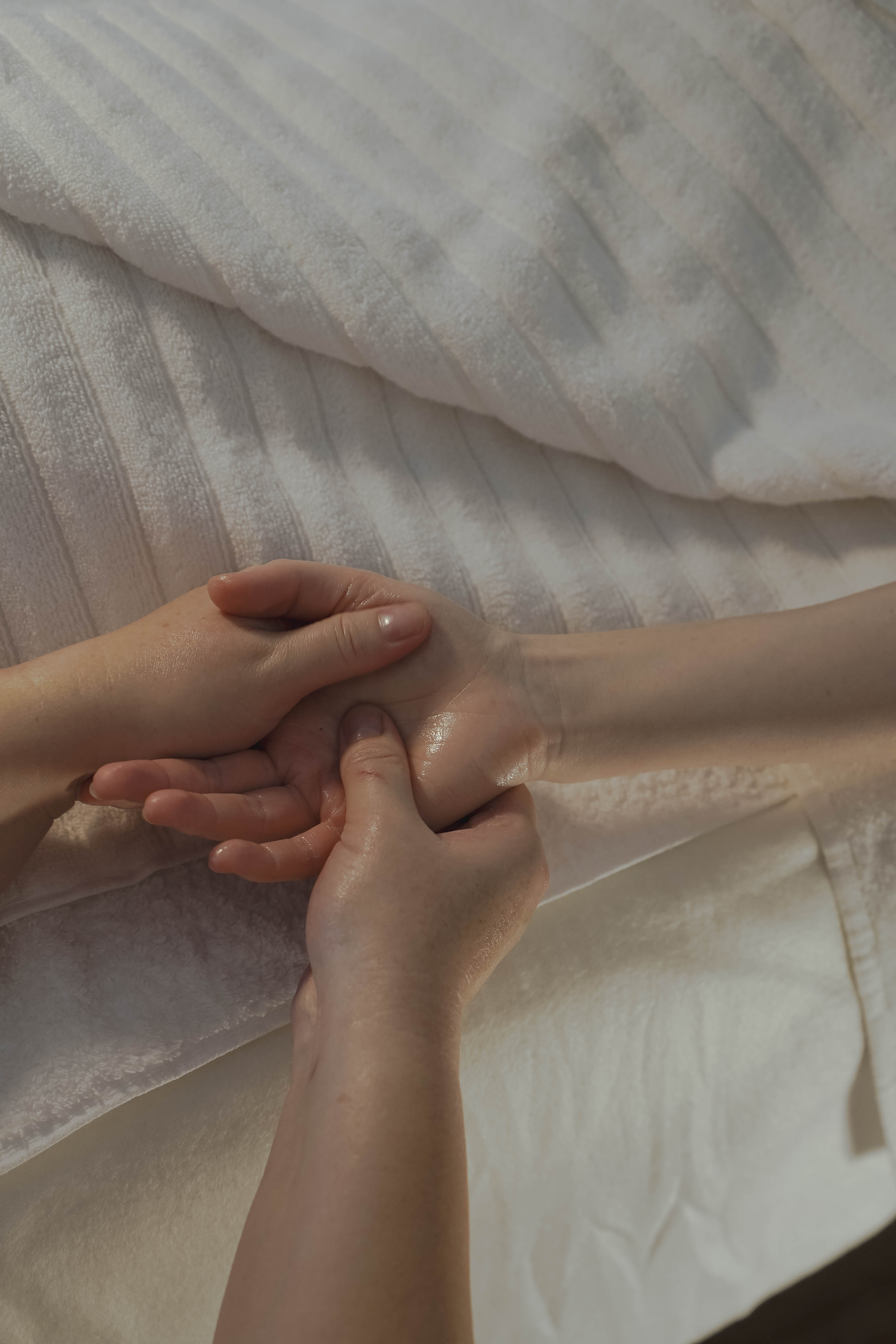 Professional therapeutic massage session with hot stones and oils