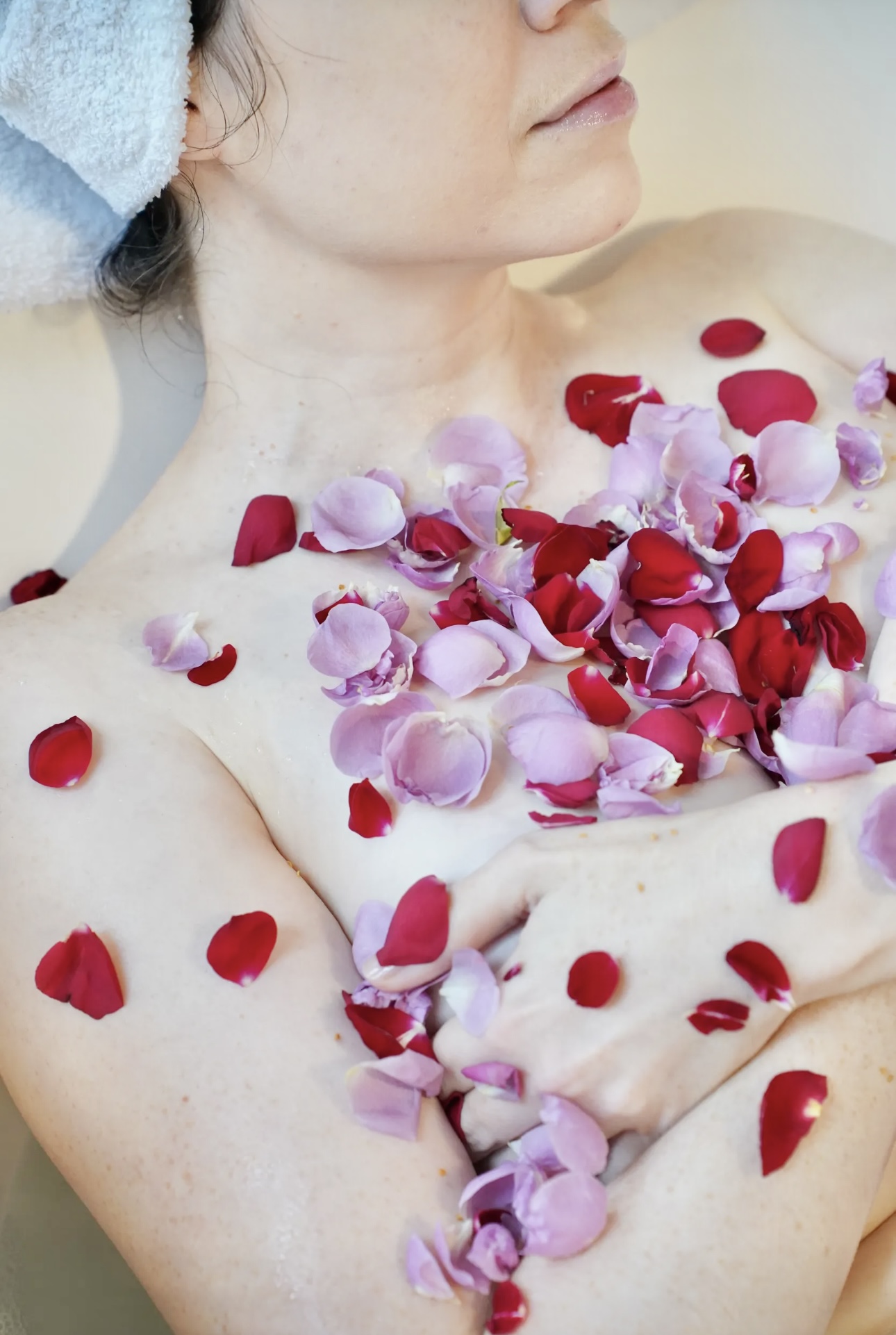 Spa relaxation bath with foam, flowers and aromatherapy candles